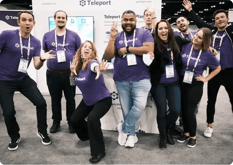 Happy Teleport employees at a convention booth