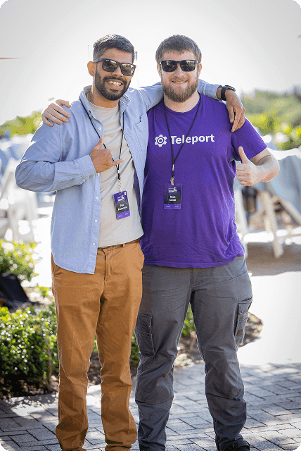 Two Teleport employees smiling and posing